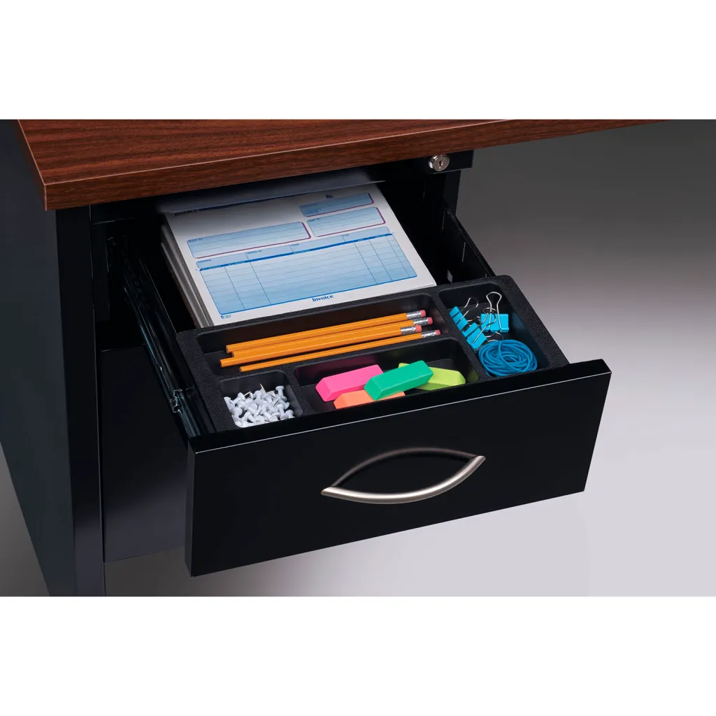 Close-up of desk drawer contents including stationery and school supplies in a divided tray.