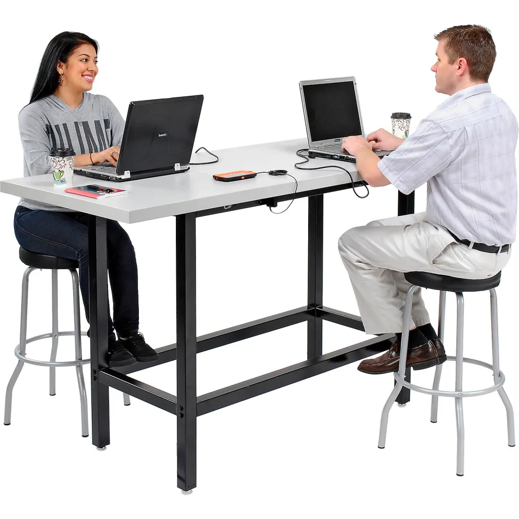 Two people working at standing desk with laptops