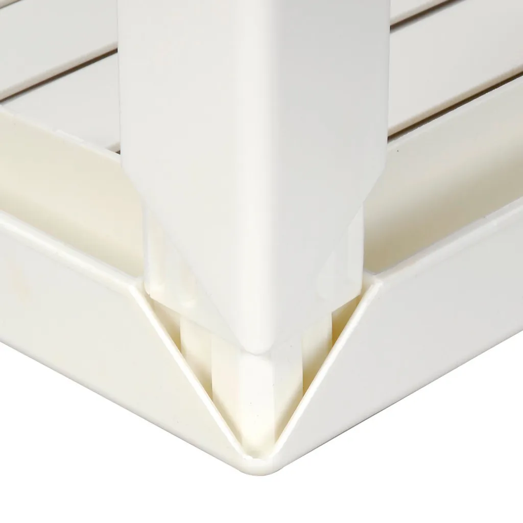 A close-up of the corner of a white plastic table