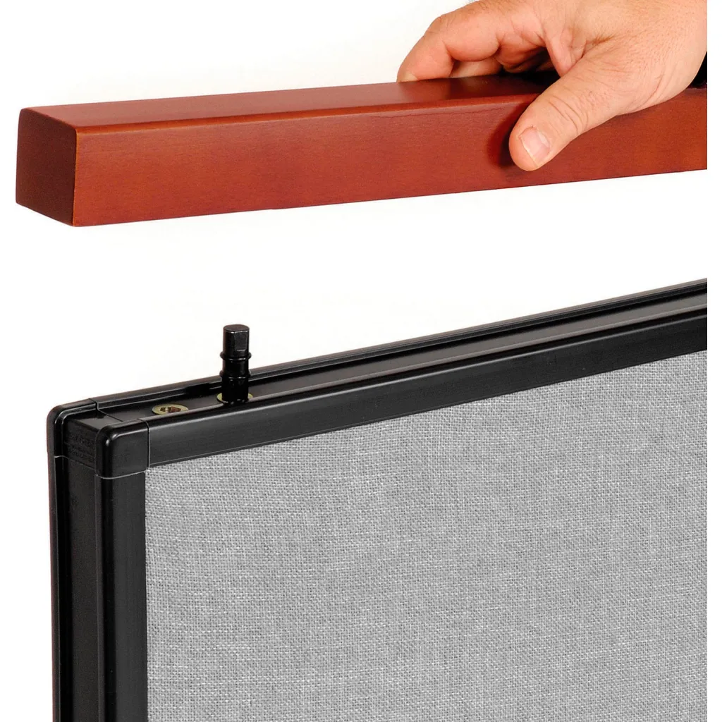 Hand holding brown wood top of room divider panel and close-up of black frame and gray fabric