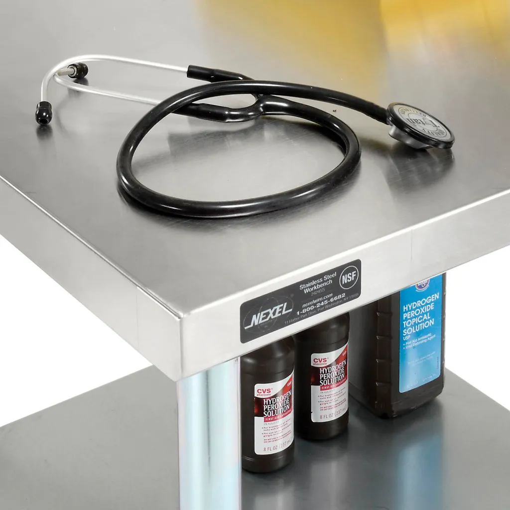Close-up of stainless steel workbench with stethoscope and bottles