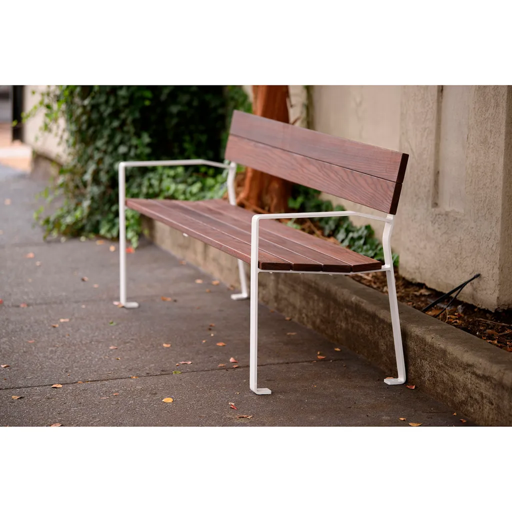Brown and white metal bench on sidewalk