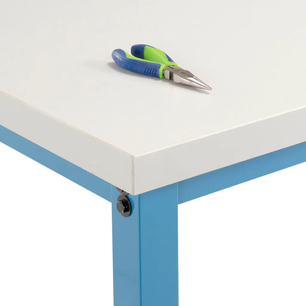 A close-up of a workbench corner with a pair of pliers