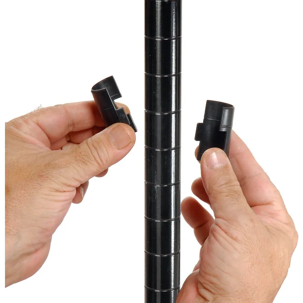 Two hands holding black plastic pieces, with a black metal shelving unit pole in the center.