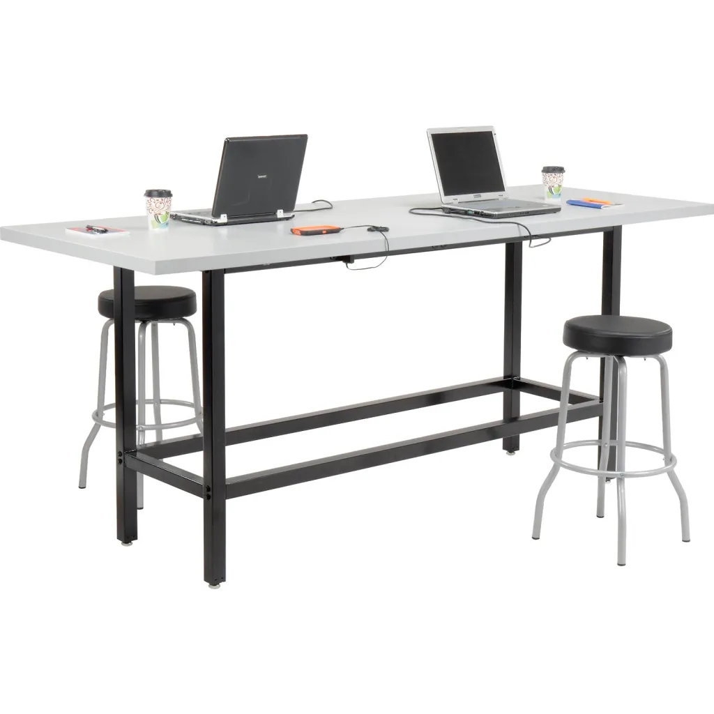Standing desk with gray top and black frame, two laptops, and two stools