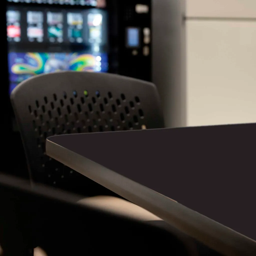 Corner of black table with chair