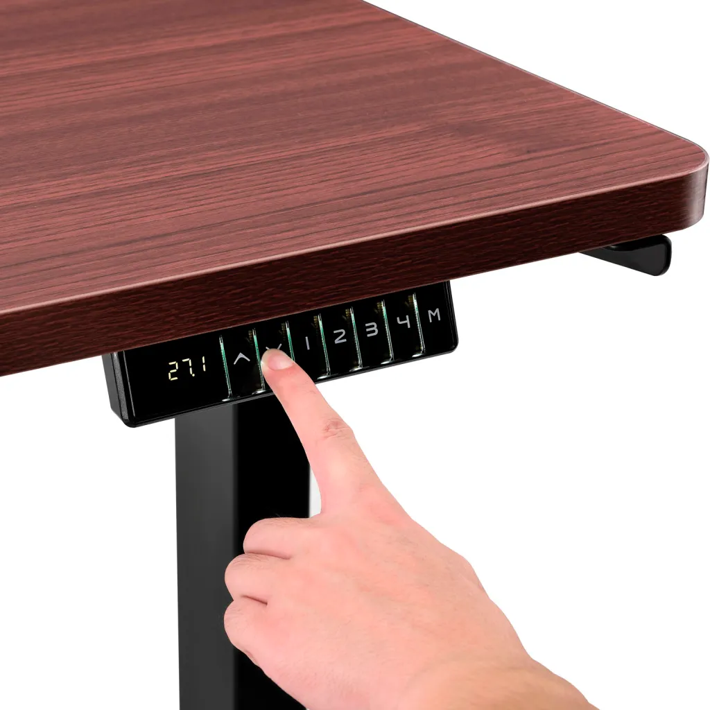 Close-up of standing desk control panel with hand pressing button