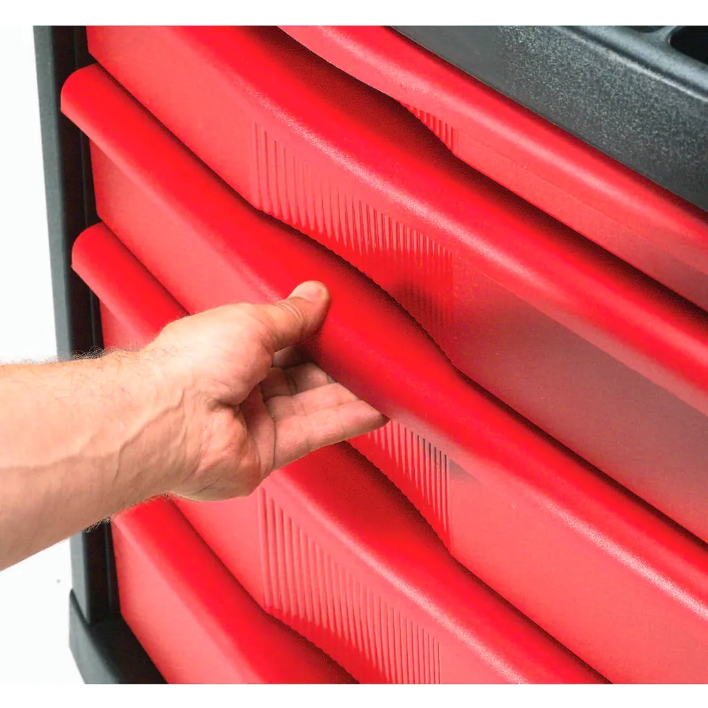A hand opening one of the red drawers on a black and red tool cart.