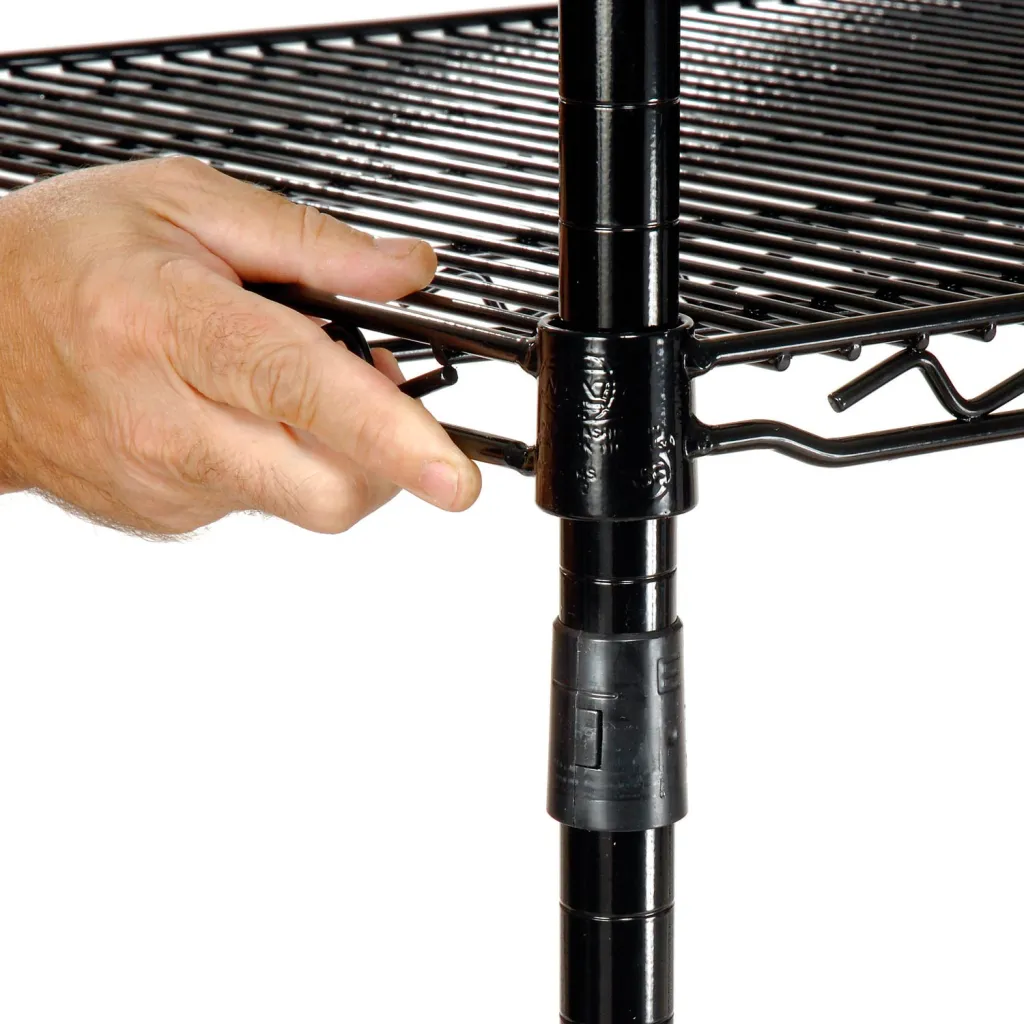 Hand attaching shelf to black metal shelving pole