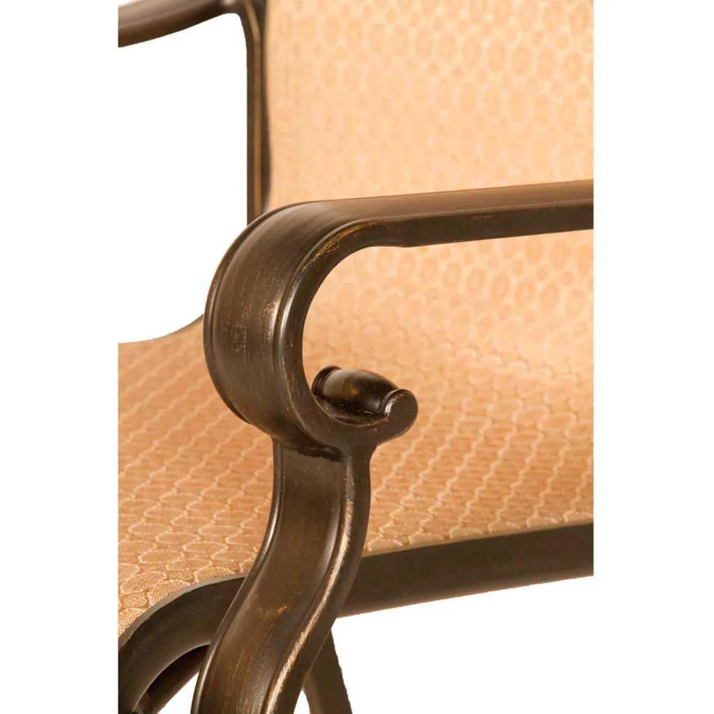 close-up of bronze-colored metal chair frame with tan fabric