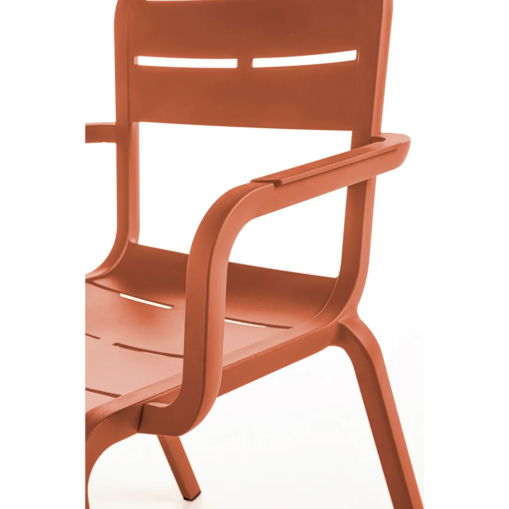 Close-up of an orange chair's armrest and seat
