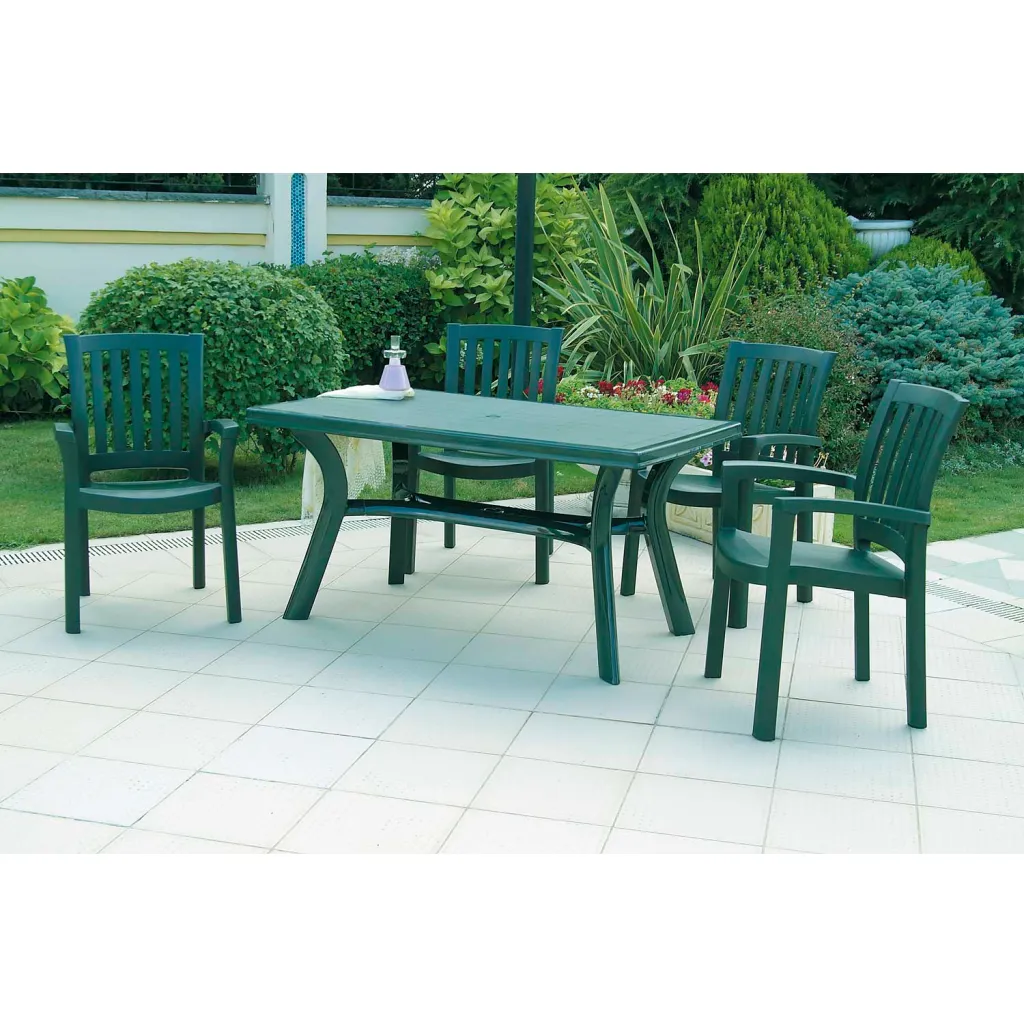 Four green plastic chairs and rectangular table on patio