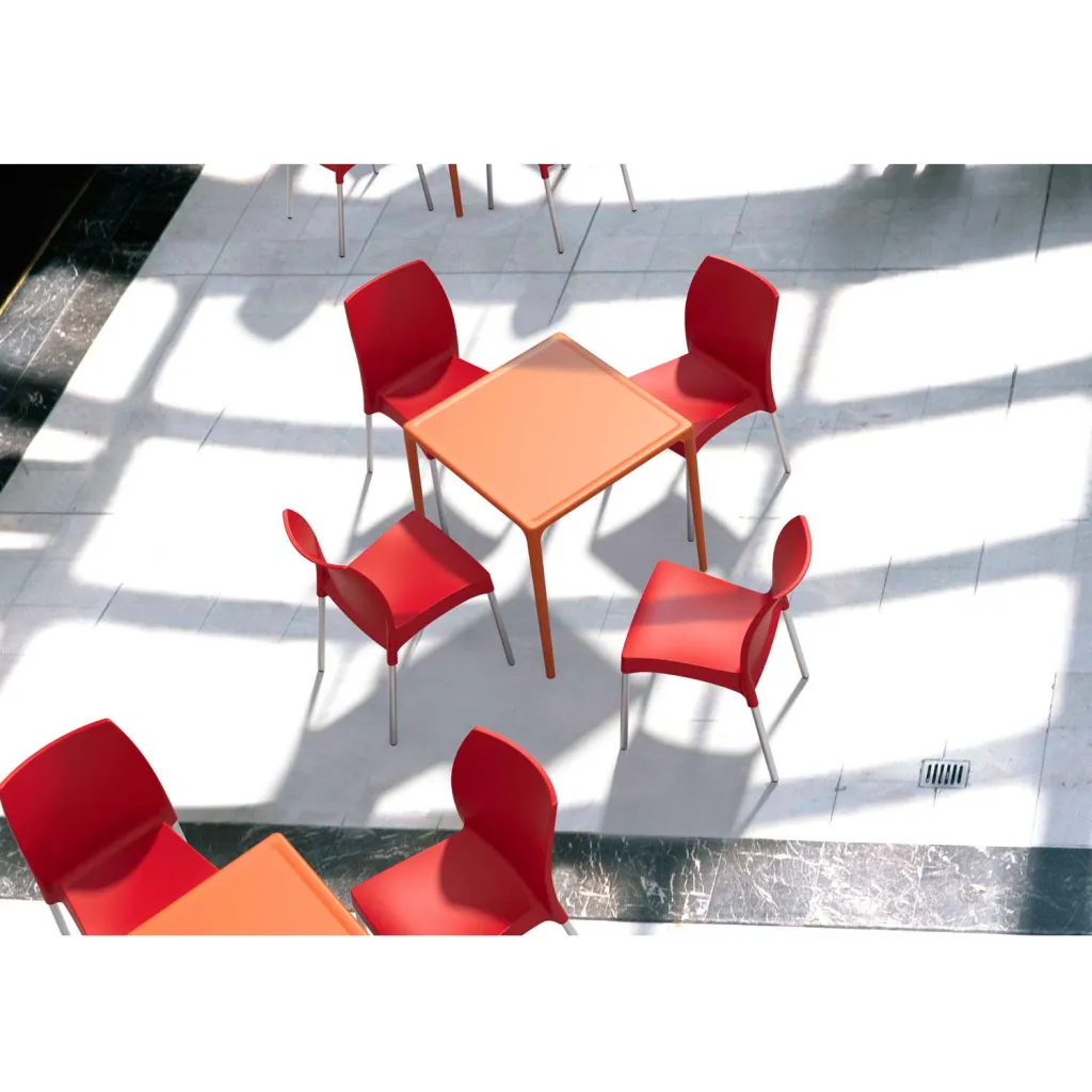 Multiple red chairs and orange tables