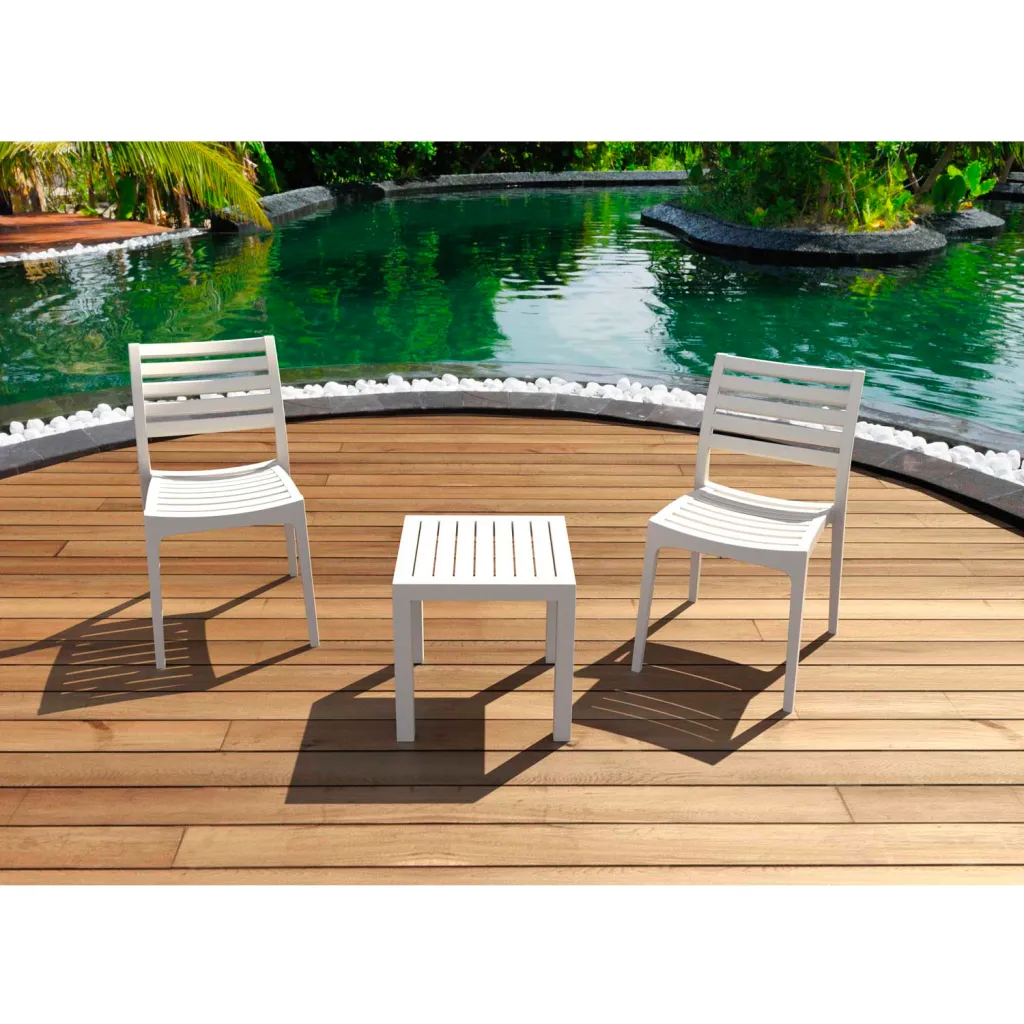 White outdoor table and chairs by pool