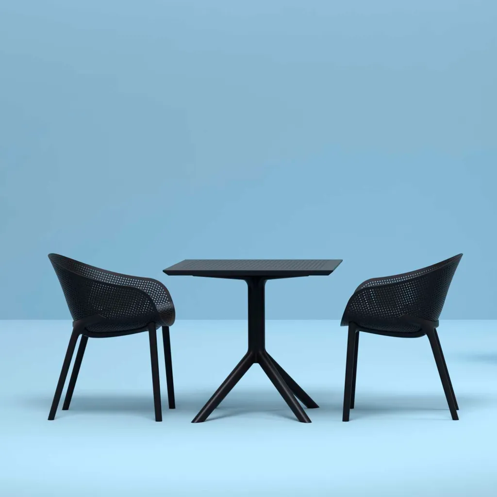Black square table with chairs, in blue room