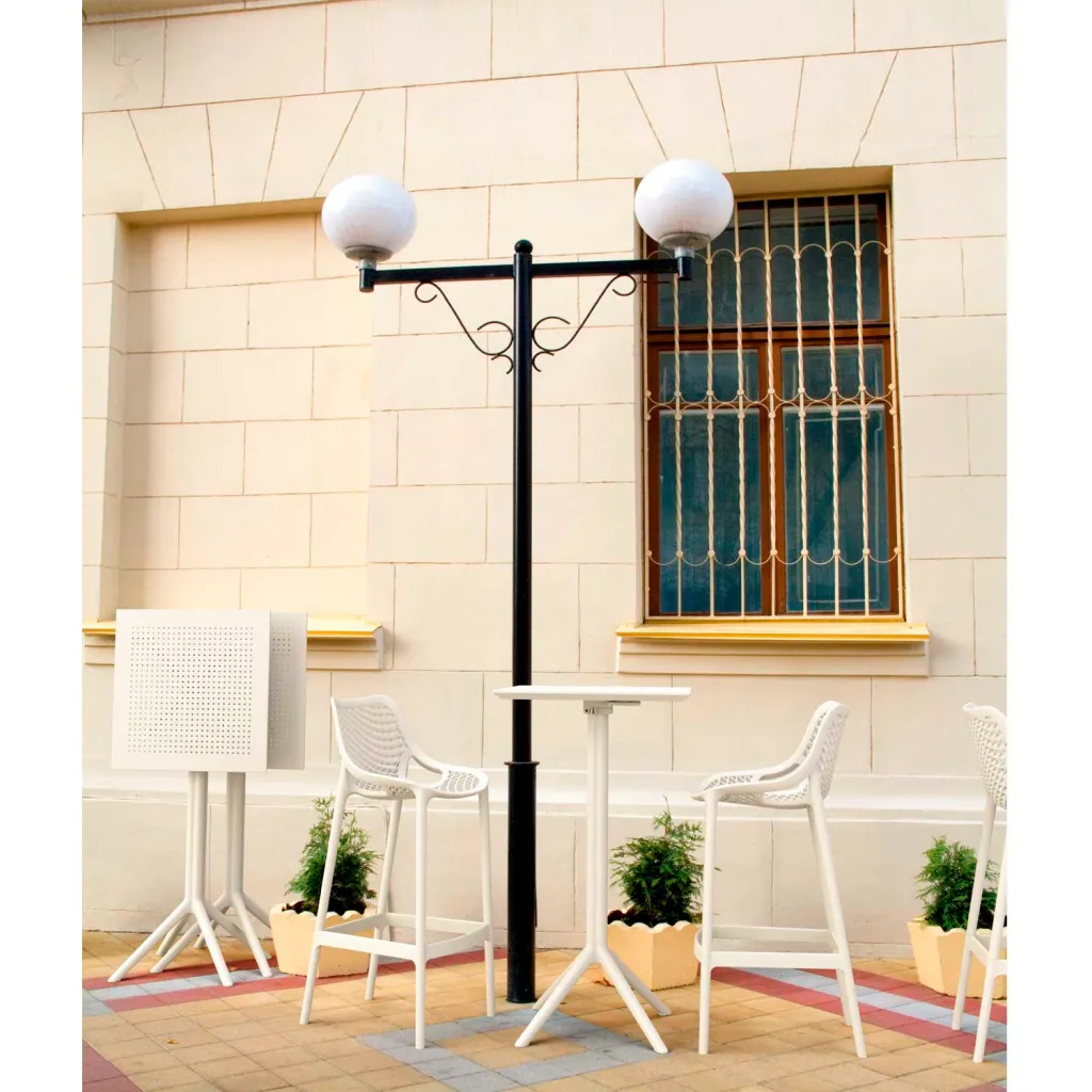 Outdoor setting with white plastic table, chairs, and sign stand