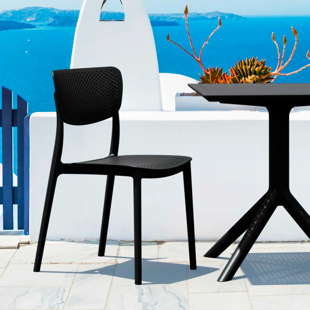 Black chair and table on a white patio