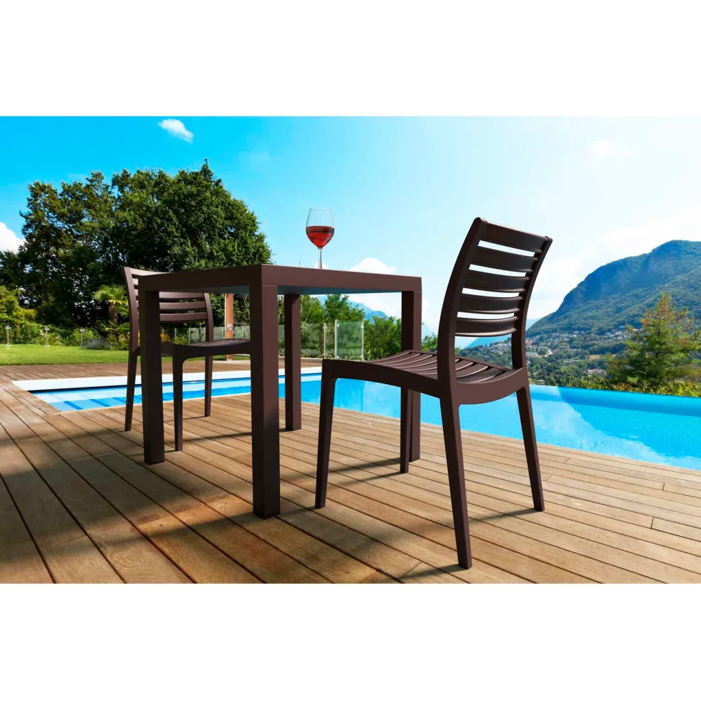 Brown outdoor table and chairs by pool