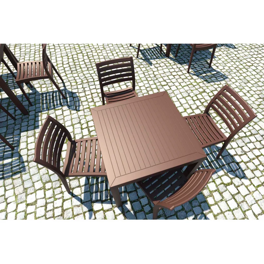 Brown outdoor table and chairs on cobblestones