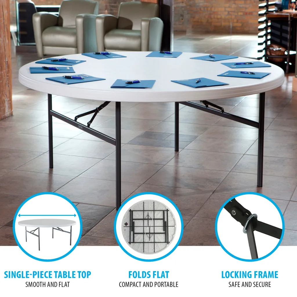 A white round table with metal legs and blue notepads and pens on top.