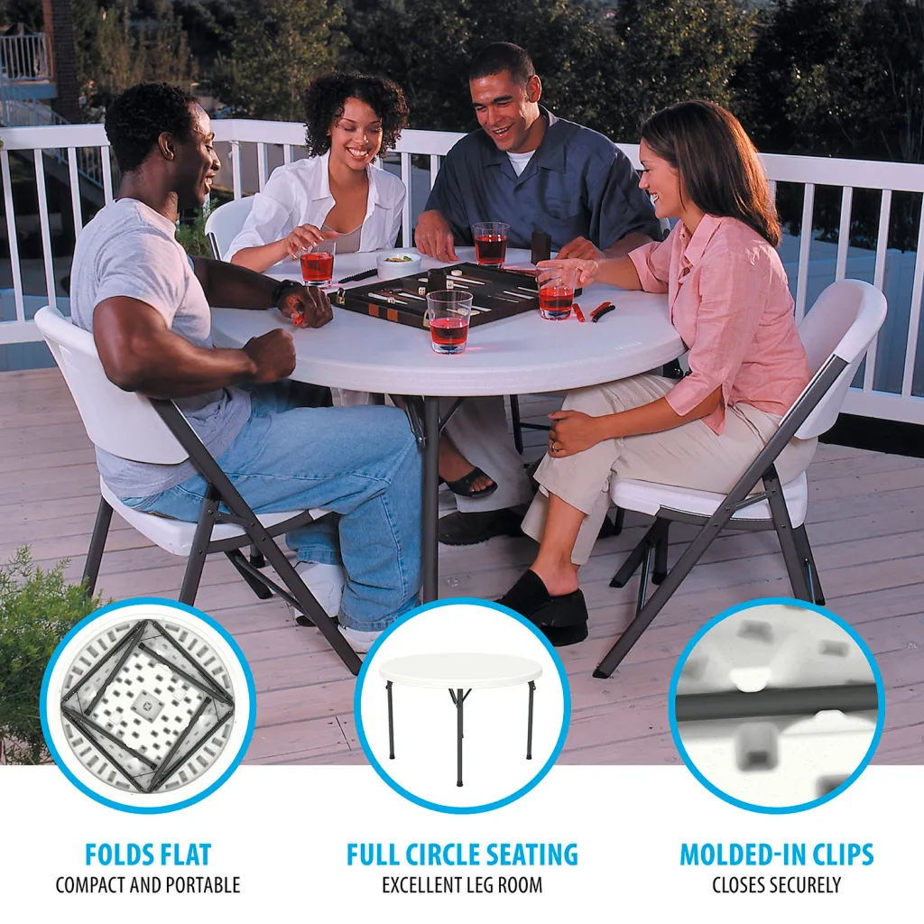 A white round folding table with black metal legs on a deck with people playing games