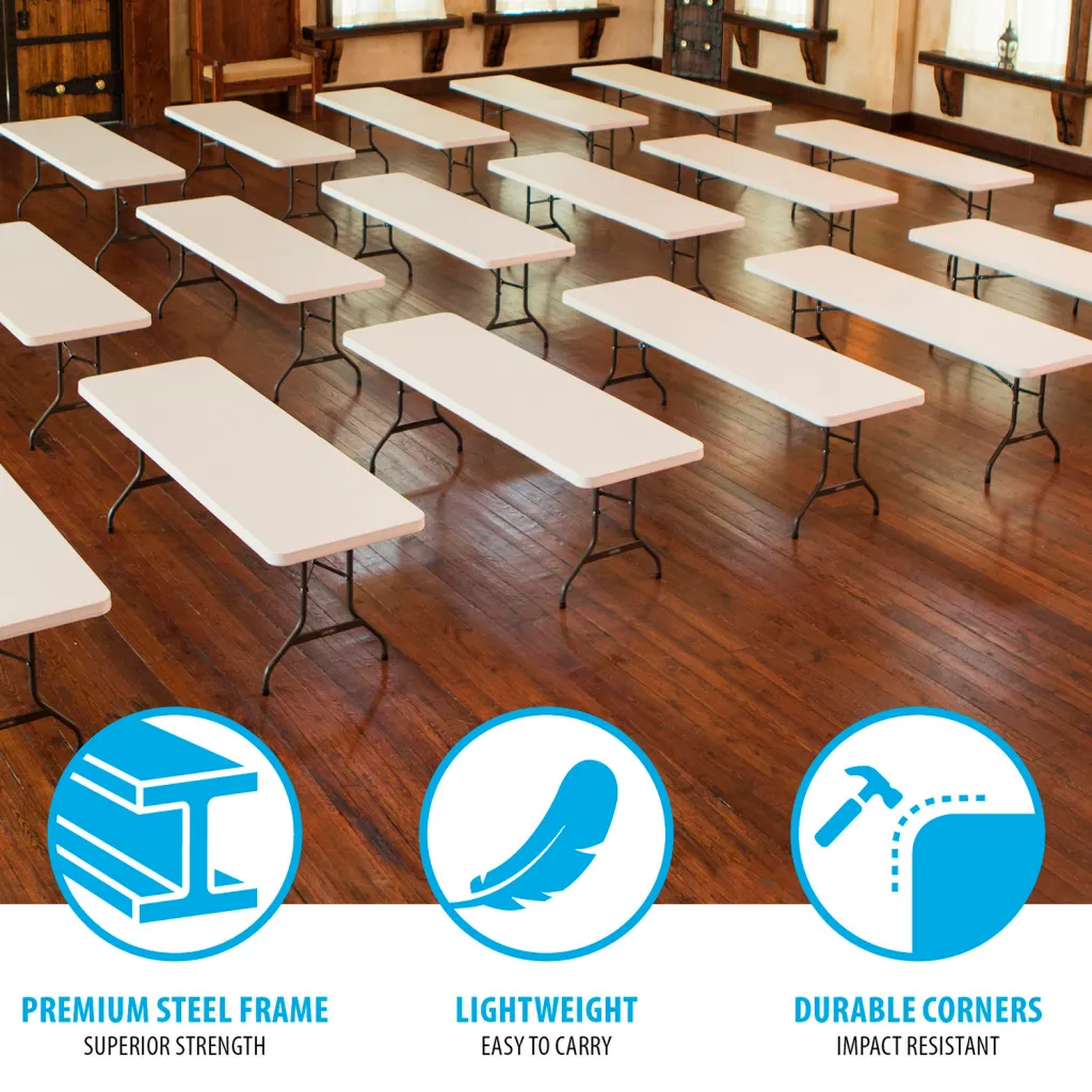 Multiple white folding tables with black metal legs set up in a room.