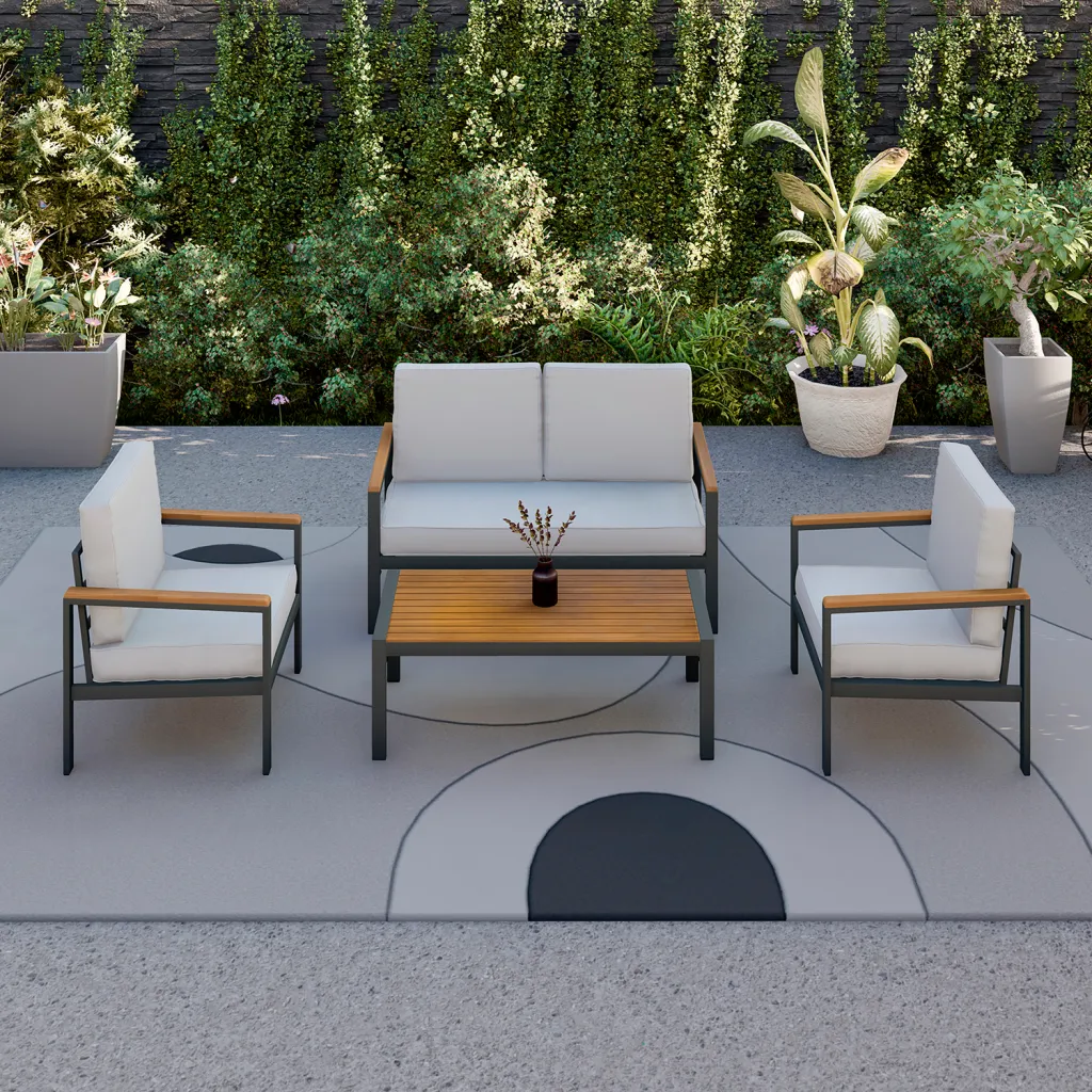 Outdoor furniture set on a patio with plants and a rug