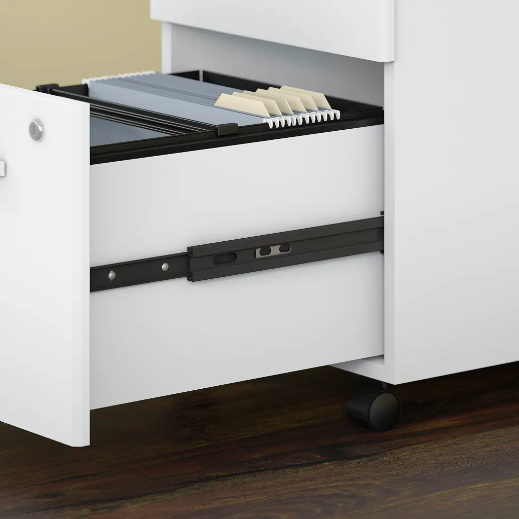 A close-up of the open drawer of a white 3-drawer filing cabinet with a black interior and beige file organizers.