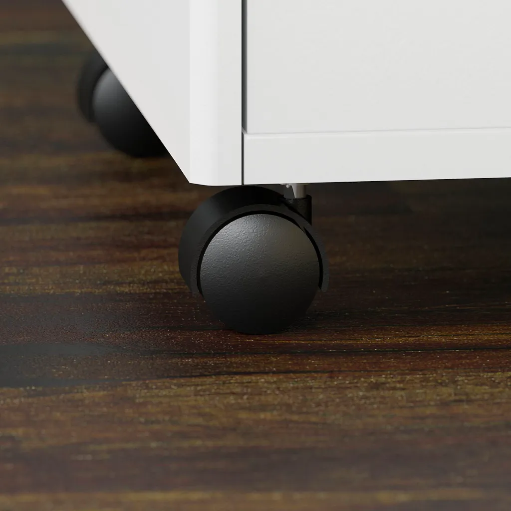 A close-up of the black wheels of a white 3-drawer filing cabinet on a dark wood floor.