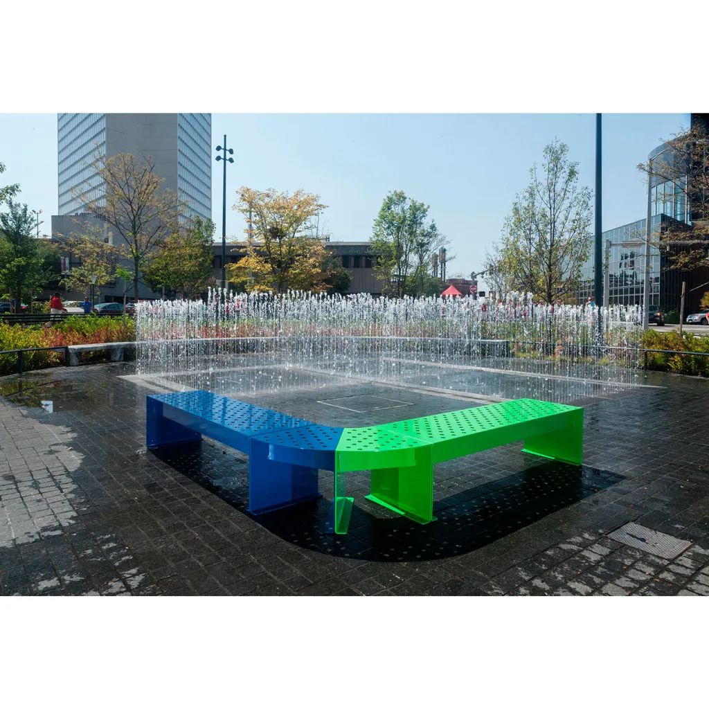 Colorful metal bench in public space with water feature