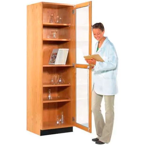 Man in lab coat reading from clipboard with open cabinet