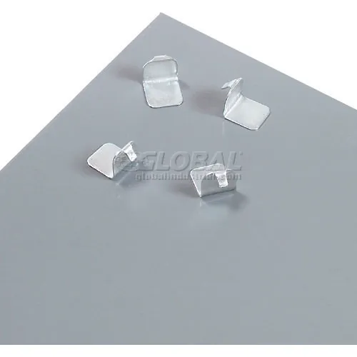 Small metal clips on gray surface